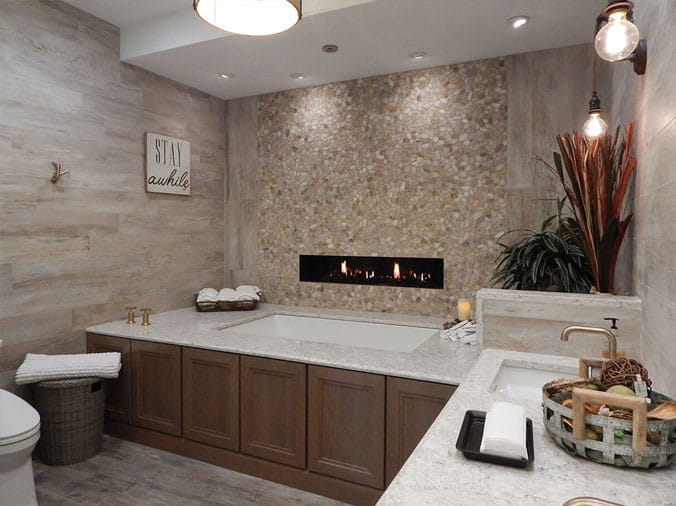Bathroom with bathtub and gas wall fireplace