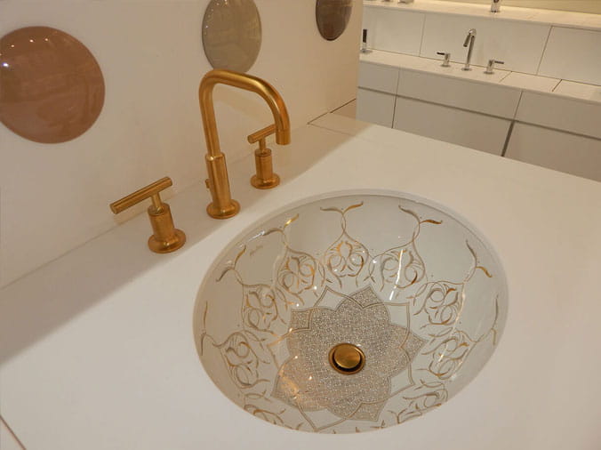 Dec orative sink basin with brushed brass faucet and fixtures
