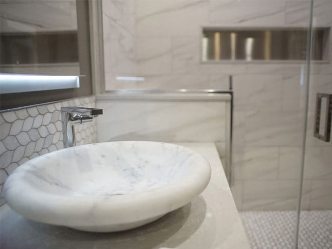 Stone sink basin with chrome faucer in the Green Art Plumbing Supply Showroom